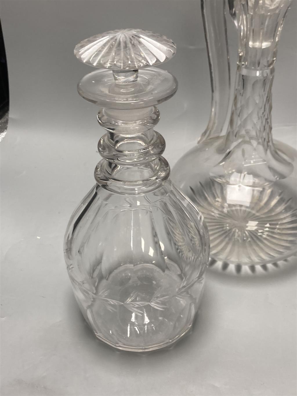 A pair of early 19th century cut glass decanters, height 24cm and an Edwardian claret jug, height 30cm (one decanter a.f.)